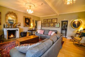 a living room with a couch and a fireplace at The Quay House in Clifden