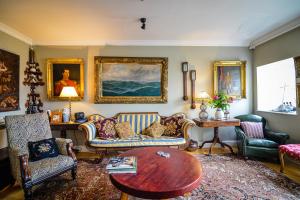 a living room with couches and a table at The Quay House in Clifden