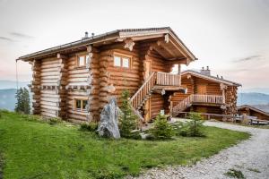 a log cabin with a staircase in front of it at Klippitz Resort in Klippitztorl