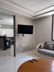 a living room with a couch and a flat screen tv at House with beautiful partial sea view in Mirleft