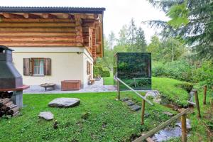 a house with a mirror in the grass in front of it at Apartment Bad Kleinkirchheim - 24 Chalet direkt an der Piste mit Outdoor Sauna in Bad Kleinkirchheim +44 photos