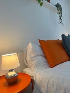 a bed with a table with a lamp on it at Flo und Vanessas Ferienwohnungen in Stubenberg