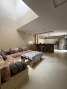 a living room with a couch and a table at House with beautiful partial sea view in Mirleft