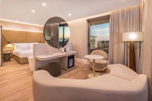 a hotel room with a bed and a mirror at Castelo Suites Hotel in Albufeira +42 photos