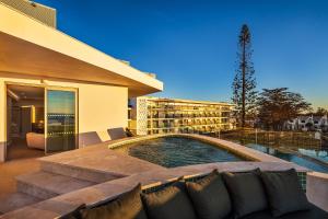 a building with a swimming pool in front of a building at Castelo Suites Hotel in Albufeira