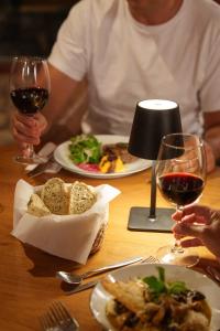 a table with two plates of food and two glasses of wine at Sentio Camps - All Inclusive in Cabra Corral