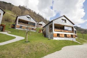a house on a hill with a tree in front of it at Smaragdresort Chalet Bergblick in Bramberg am Wildkogel