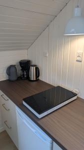 a laptop computer sitting on a counter in a kitchen at Henneby Camping - hytter in Henne Strand