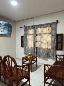 a room with chairs and a table and a window at Casa Ale in Brisas de Zicatela