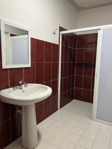 a bathroom with a sink and a mirror at Casa Ale in Brisas de Zicatela