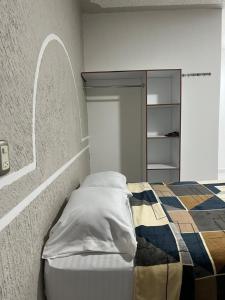 a bedroom with a bed and a wall with a mirror at Casa Ale in Brisas de Zicatela +14 photos