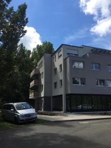 a car parked in front of a building at Thermal Forest Apartment in Kiskunhalas