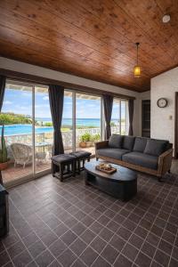 a living room with a couch and a view of the ocean at 478 retreat in Yoron