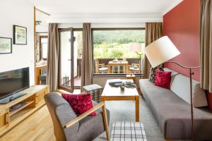 a living room with a couch and a table at Seehaus Verena in Weissensee