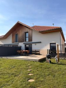 a house with a grass yard in front of it at Maison La Bullette à 10 min de Pontarlier in Bulle