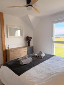 a bedroom with a large bed with towels on it at Maison La Bullette à 10 min de Pontarlier in Bulle