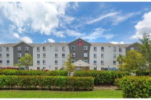 a large apartment building with a h sign on it at Studio 6 Extended Stay Fort Myers FL in Fort Myers