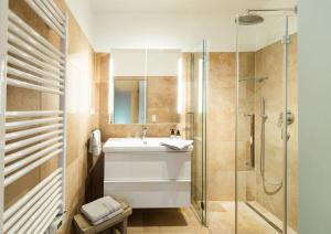a bathroom with a sink and a shower at Seehaus Verena in Weissensee +29 photos