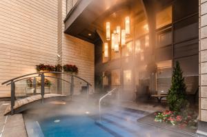 a swimming pool in the lobby of a hotel at Metcalfe Hotel Montréal by Gray Collection in Montreal