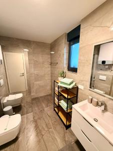 a bathroom with a toilet and a sink at Seaview Residence Krk 2 Bedrooms 2 Bathrooms Free Parking in Krk