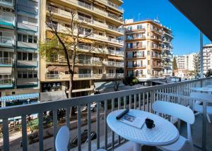 a balcony with a table with a book on it at Pillow by the Sea in Thessaloniki