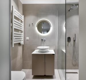 a bathroom with a sink and a mirror at Pillow by the Sea in Thessaloniki +65 photos