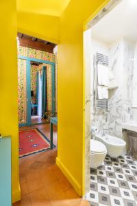 a yellow bathroom with a toilet and a sink at Incentrum in Rome +98 photos