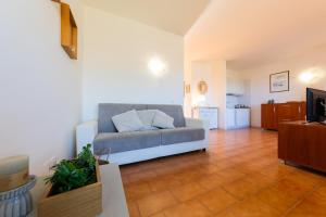 a living room with a couch and a kitchen at L10 Terrazza Ponente A breathtaking view in Stintino