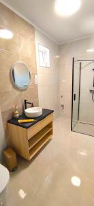 a bathroom with a sink and a mirror at MEDA Apartman in Sárvár +10 photos