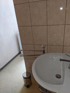 a bathroom with a toilet and a white sink at Auszeit im Vorharz in Wegeleben +2 photos