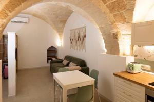 a living room with a couch and a table at Suite Bobo in Monopoli