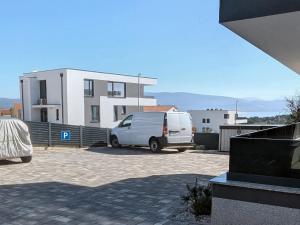 a white van parked in a parking lot in front of a building at Seaview Residence Krk 2 Bedrooms 2 Bathrooms Free Parking in Krk