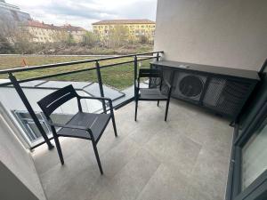 a balcony with two chairs and a table at LaRa Apartament in Timişoara
