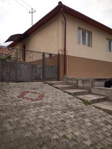 a house with a gate and steps in front of it at Casa Tineretului in Dej +1 photo