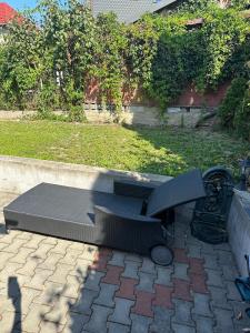a bench sitting on top of a patio at Casa Tineretului in Dej