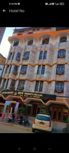 a hotel with a car parked in front of it at New Shanti Hotel in Prayagraj
