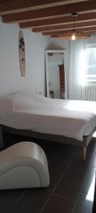 a white bed in a room with a mirror at Escapade Maritime in Dompierre-sur-Mer +9 photos