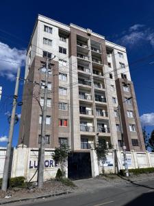 a tall building with a sign on the side of it at Luxore Apartments Syokimau No E803 in Syokimau