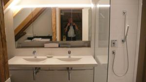 a person taking a picture of a bathroom with a sink at Design trifft Denkmal in Wangen im Allgäu +27 photos