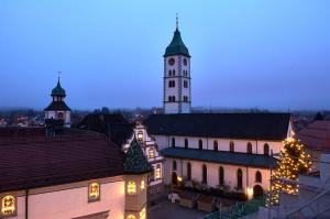 a building with a clock tower with a christmas tree at Design trifft Denkmal in Wangen im Allgäu