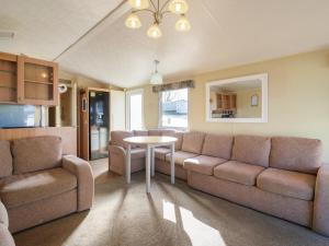 a living room with a couch and a table at Ocean Breeze Escape in Rochester