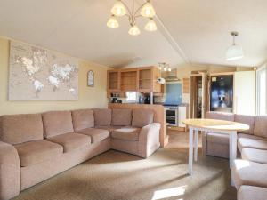 a living room with a couch and a table at Ocean Breeze Escape in Rochester