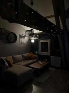 a living room with a couch and a table at Charmant loft industriel de 40m2 in Aubignan