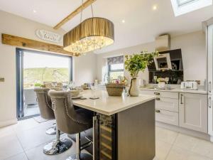 a kitchen with a large island with a table and chairs at 2 Bed in Skipton oc-82602 in Buckden