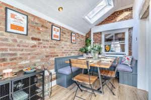 a dining room with a brick wall and a table and chairs at 3 Bed in Belper oc-o28261 in Belper