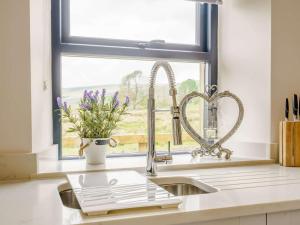 a kitchen sink with a window and two hearts at 2 Bed in Skipton oc-82602 in Buckden +17 photos