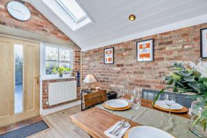 a dining room with a brick wall at 3 Bed in Belper oc-o28261 in Belper
