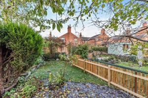 a garden in front of a house with a wooden fence at 3 Bed in Belper oc-o28261 in Belper +20 photos