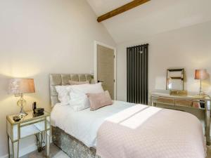 a bedroom with a large white bed and a desk at 2 Bed in Skipton oc-82602 in Buckden
