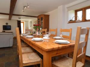 a dining room with a wooden table and chairs at 4 Bed in Sherborne oc-folow in Long Burton